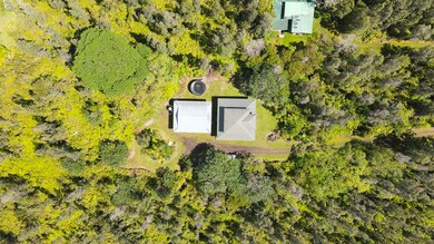 Aerial view of catchment tank, garage, and house