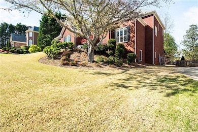 View of side of property featuring a lawn, brick s