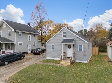 View of front of home featuring a front yard and driveway