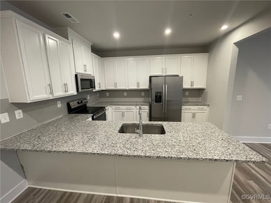 Kitchen with stainless steel appliances, a sink, d