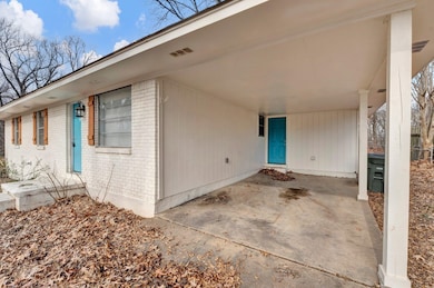 Entrance to property featuring a carport