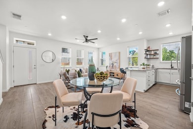 Dining room with light wood finished floors, recessed lighting, and a ceiling fan