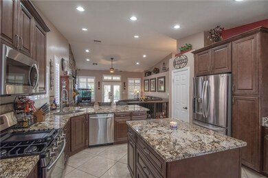 Chefs kitchen overlooks cozy family room featuring