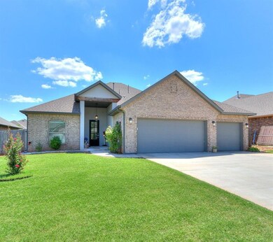 Single story home with a front yard and a garage