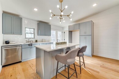 A new kitchen with gas range and decorative lighti