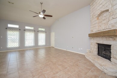 Gorgeous stone fireplace with gas logs and wood mantle.