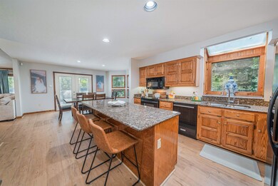 Kitchen featuring light wood-type flooring, stone 