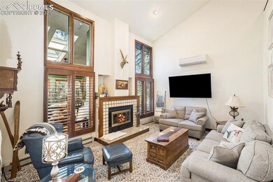 Living room with high vaulted ceiling, a tiled fir