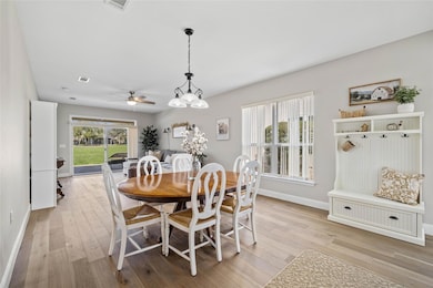 Dining room with light wood-style floors and a ce