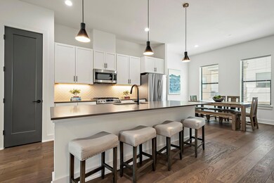 Kitchen with tasteful backsplash, appliances with