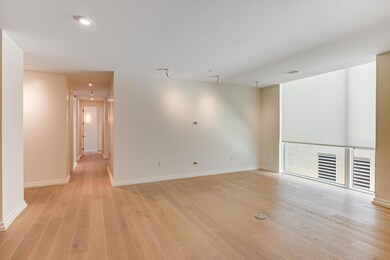 Empty room with visible vents, light wood finishe
