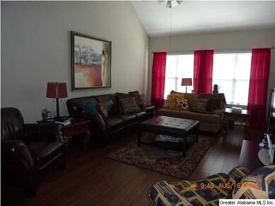 Great Room with Wide Plank Hardwood Floors and Win