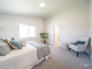 Bedroom with vaulted ceiling and carpet flooring