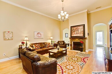Spacious Great Room features hardwood floors, raised ceilings, and gas log fireplace.