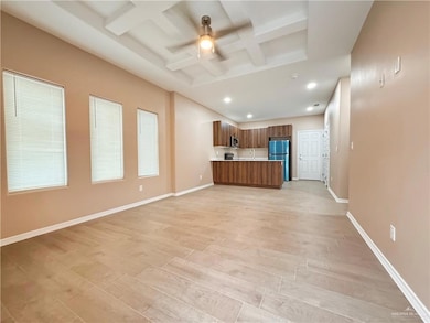 Unfurnished living room with beamed ceiling, ceiling fan, light hardwood / wood-style floors, and coffered ceiling