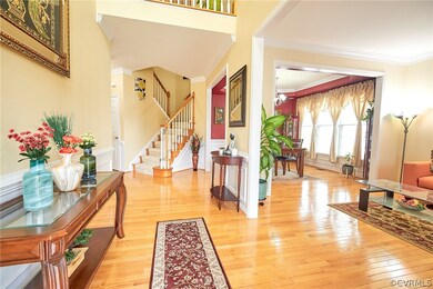 Foyer with a notable chandelier, ornamental moldin