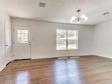 Charming curb appeal with mature trees, a spacious driveway and  attached carport.
