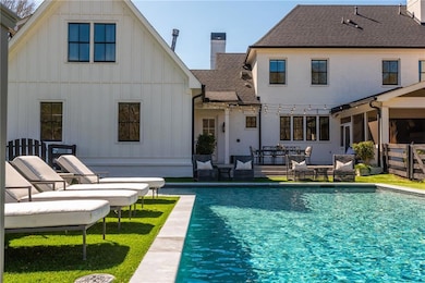 Gorgeous in ground pool with water feature and custom swim spa with sun deck