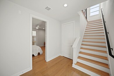 Wood stairs with sleek railing detail lead to the