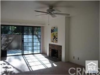 Living room with gas fireplace, ceiling fan and sl