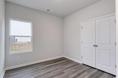 Unfurnished bedroom featuring wood-type flooring a