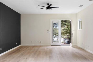 Spare room featuring ceiling fan, light wood-type