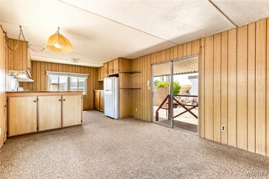 Kitchen featuring freestanding refrigerator, wood