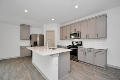 Equipped with a Fridge, this Kitchen has been upgraded with Hardware and Grey Cabinets!