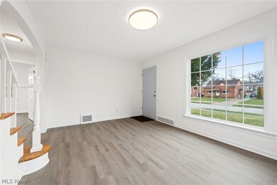 Living  room featuring light wood-type flooring and a healthy amount of sunlight