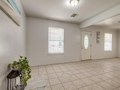 Tiled entrance foyer featuring crown molding