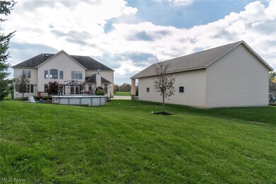 Back view of home, pool area, and outbuilding.