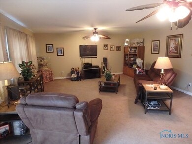 Family room with gas fireplace and 2 ceiling fans