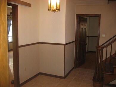 Foyer with staircase and adjoining living and dini