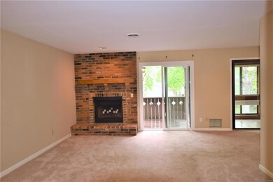 Living room has fireplace and slider to deck.