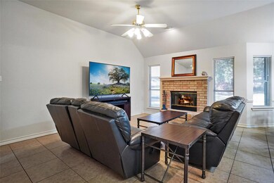 Living room featuring lofted ceiling, tile pattern