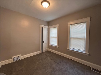 Empty room with dark carpet