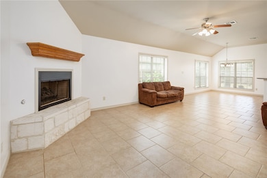 Living area featuring lofted ceiling, a fireplace