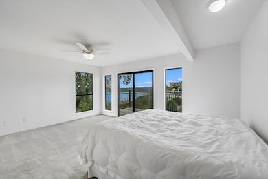 Bedroom with carpet flooring, beamed ceiling, cei