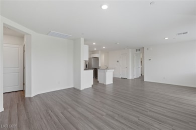 Unfurnished living room featuring light wood finished floors and recessed lighting