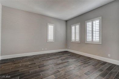 Unfurnished room with wood tiled floor and baseboa