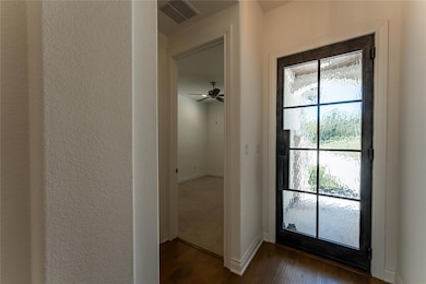 Doorway to outside featuring dark wood-style floo