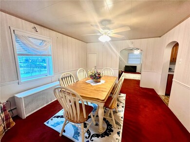 The dining room is next to the kitchen and has roo