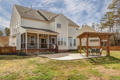 The Outdoor living space here is incredible!  Screened Porch overlooks a Stamped Concrete Patio with Pergola including electricity!