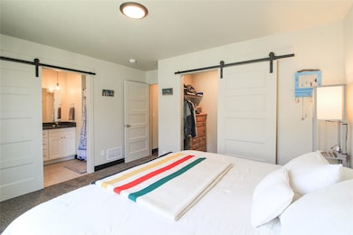 Primary bedroom with an attached bathroom & closet