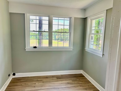 Empty room featuring wood finished floors and baseboards
