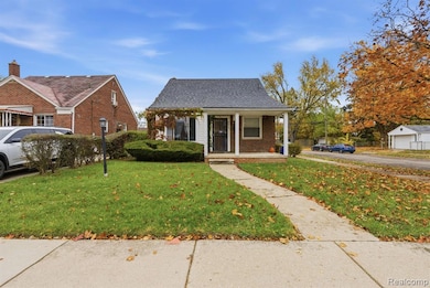 Bungalow-style home with a porch, a front lawn, roof with shingles, and brick siding