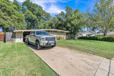 Ranch-style home featuring a front lawn and a carp