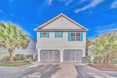 View of front of home featuring driveway, an attac