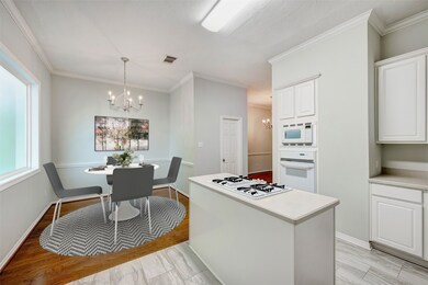 The island kitchen boasts a sunny breakfast nook p