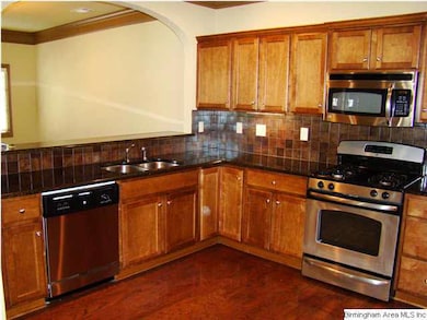 2nd view of kitchen has breakfast bar.